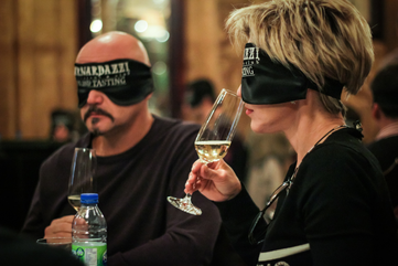 Two people blind-tasting wine